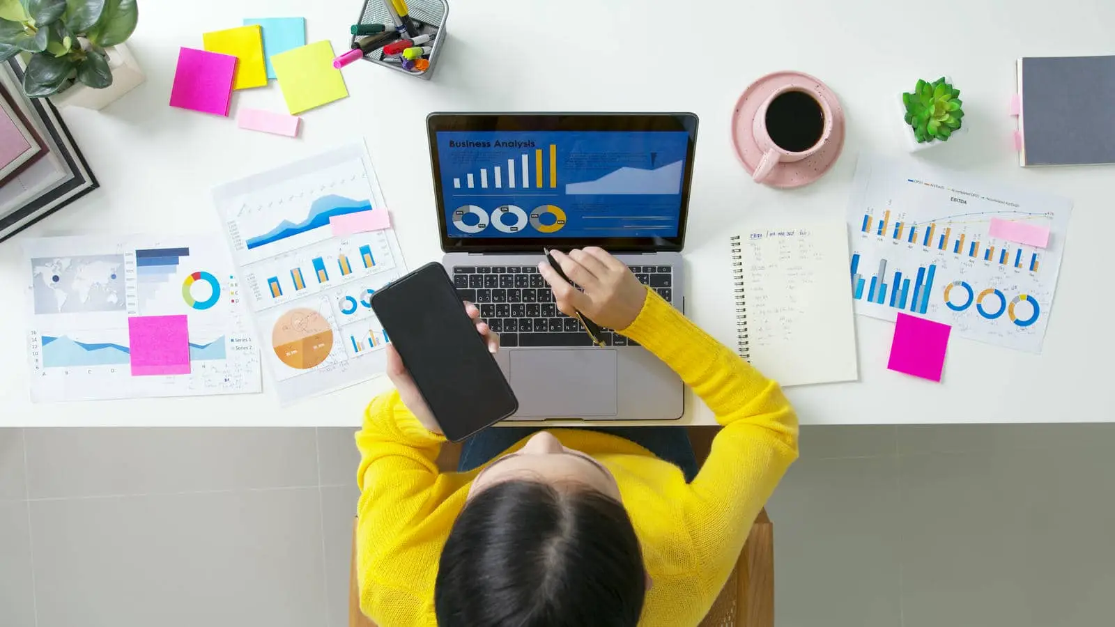 Top view of a person analyzing business data on a laptop, showcasing the professional SEO optimization service for business growth